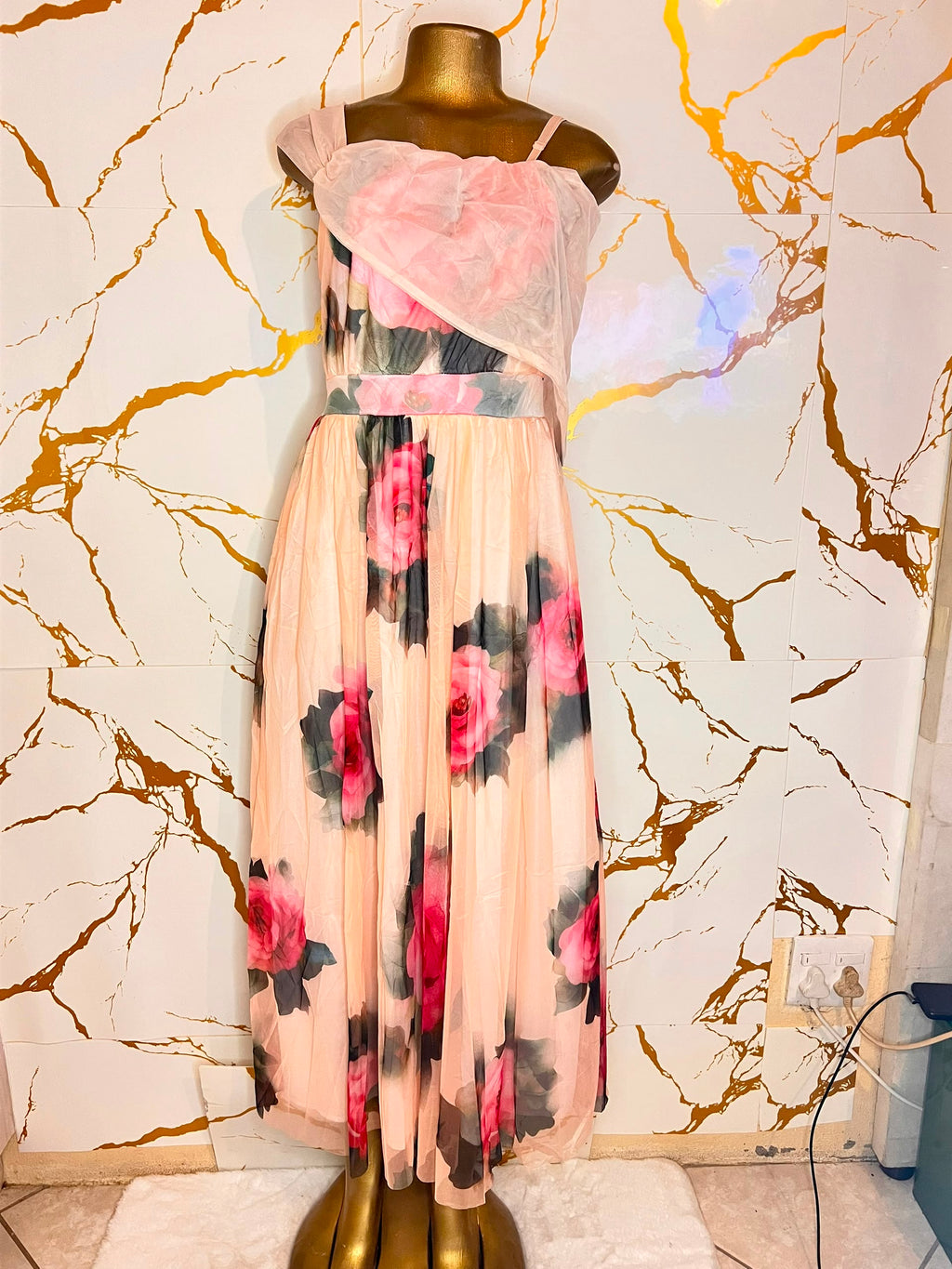 Peach-colored maxi dress with a pink and black floral print