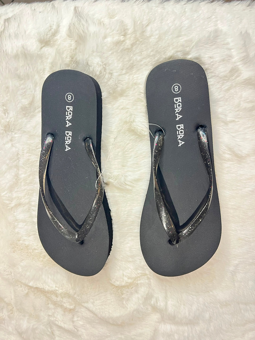 Black flip-flops with glittery metallic straps