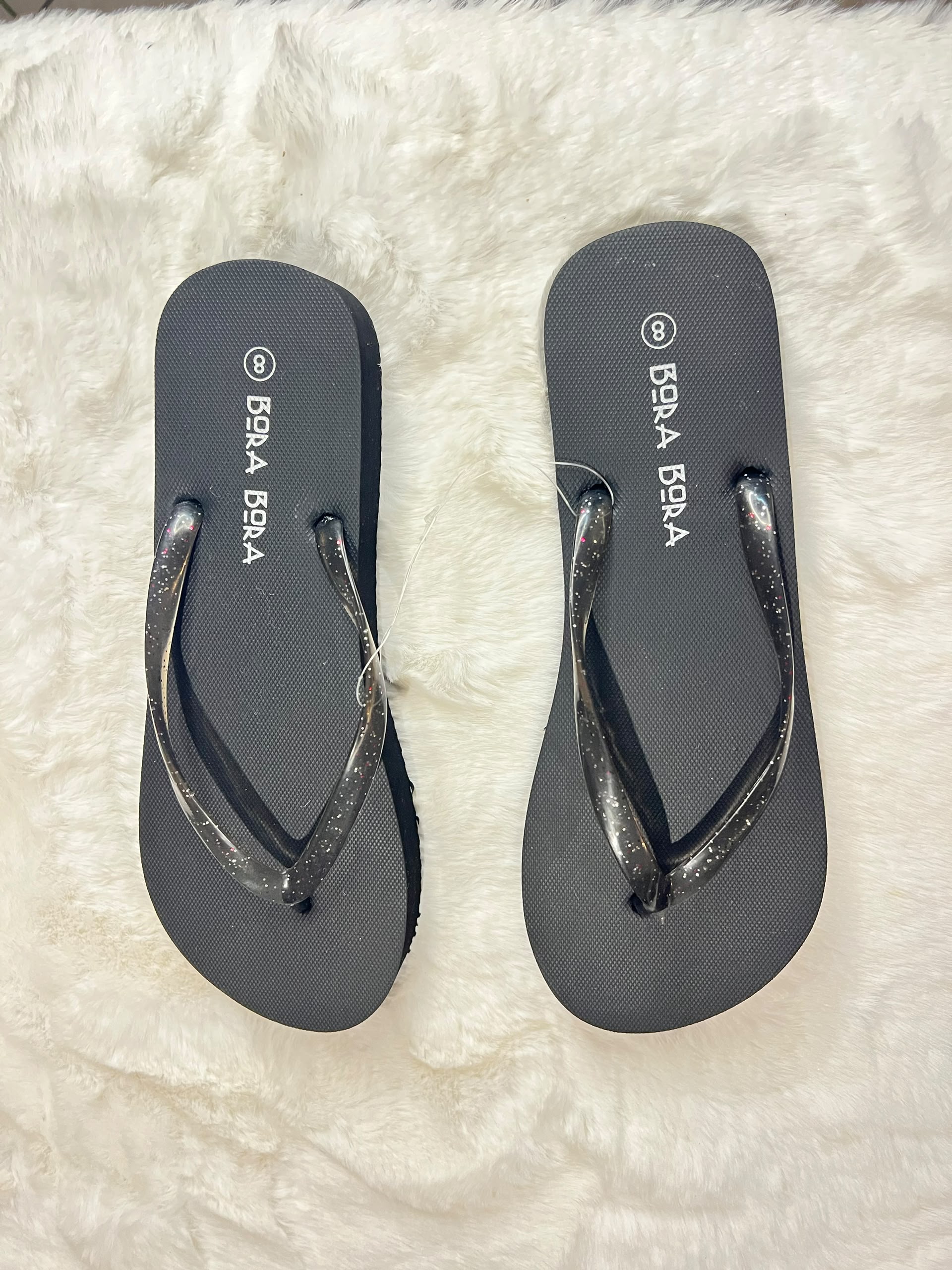 Black flip-flops with glittery metallic straps