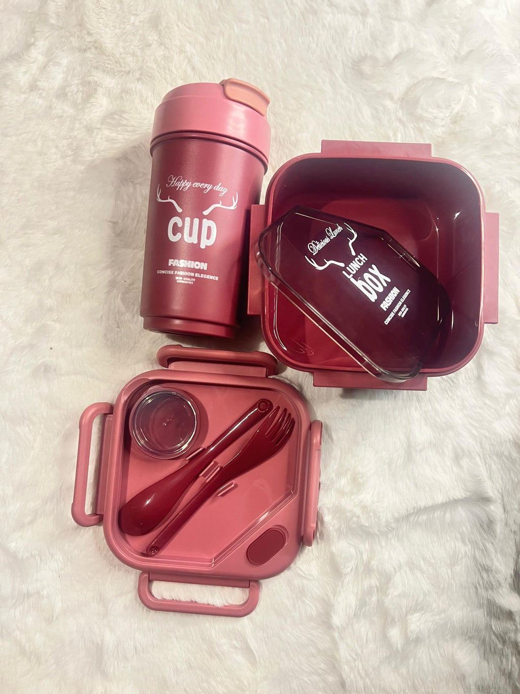 A pink lunch box set with a matching insulated cup