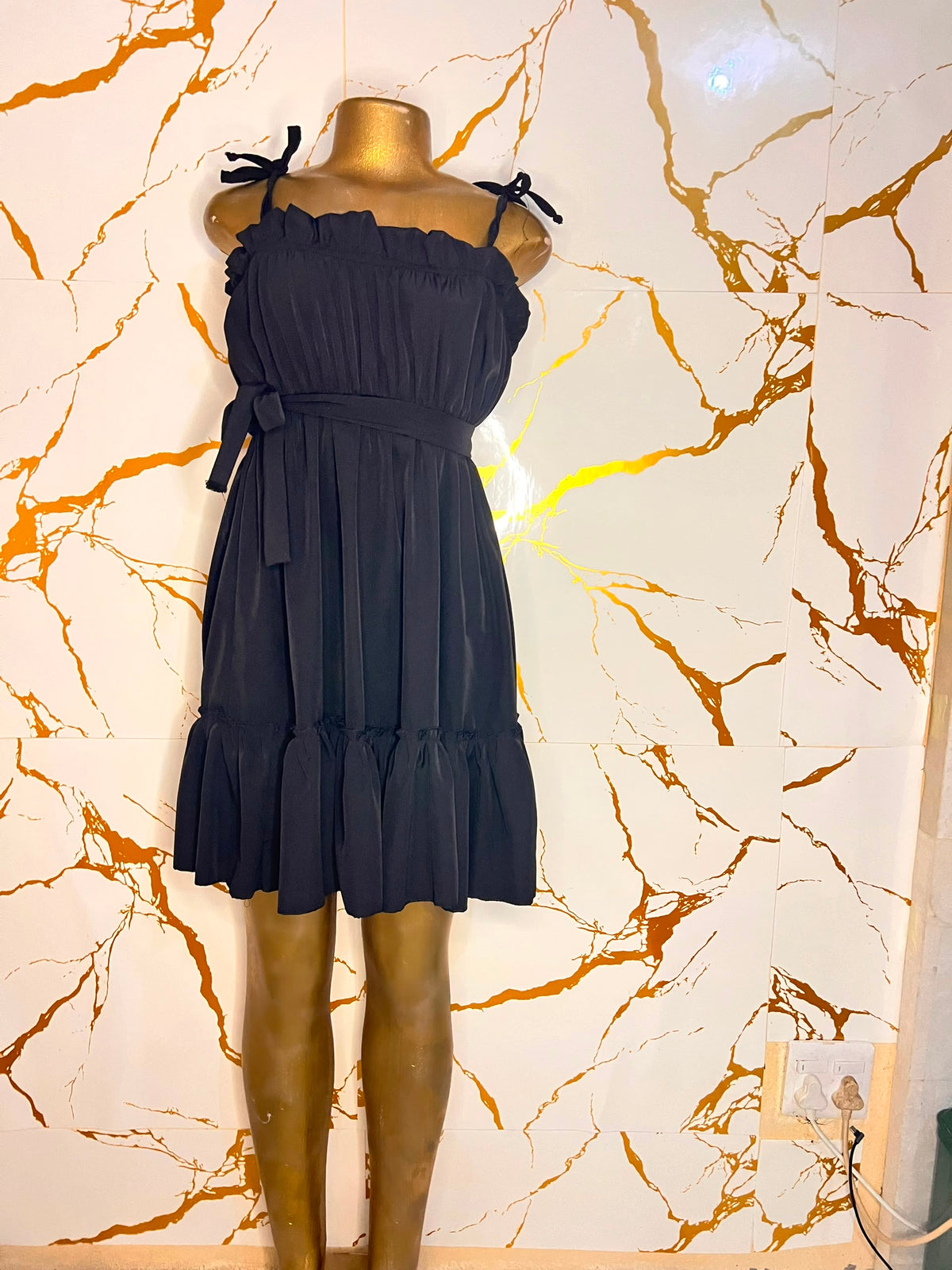 A black sleeveless ruffled mini dress 