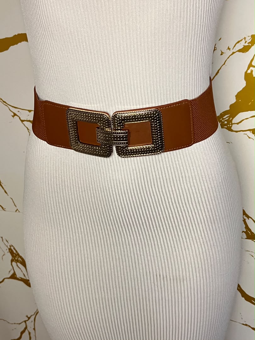 A brown wide belt with a large square buckle embellished with dark rhinestones