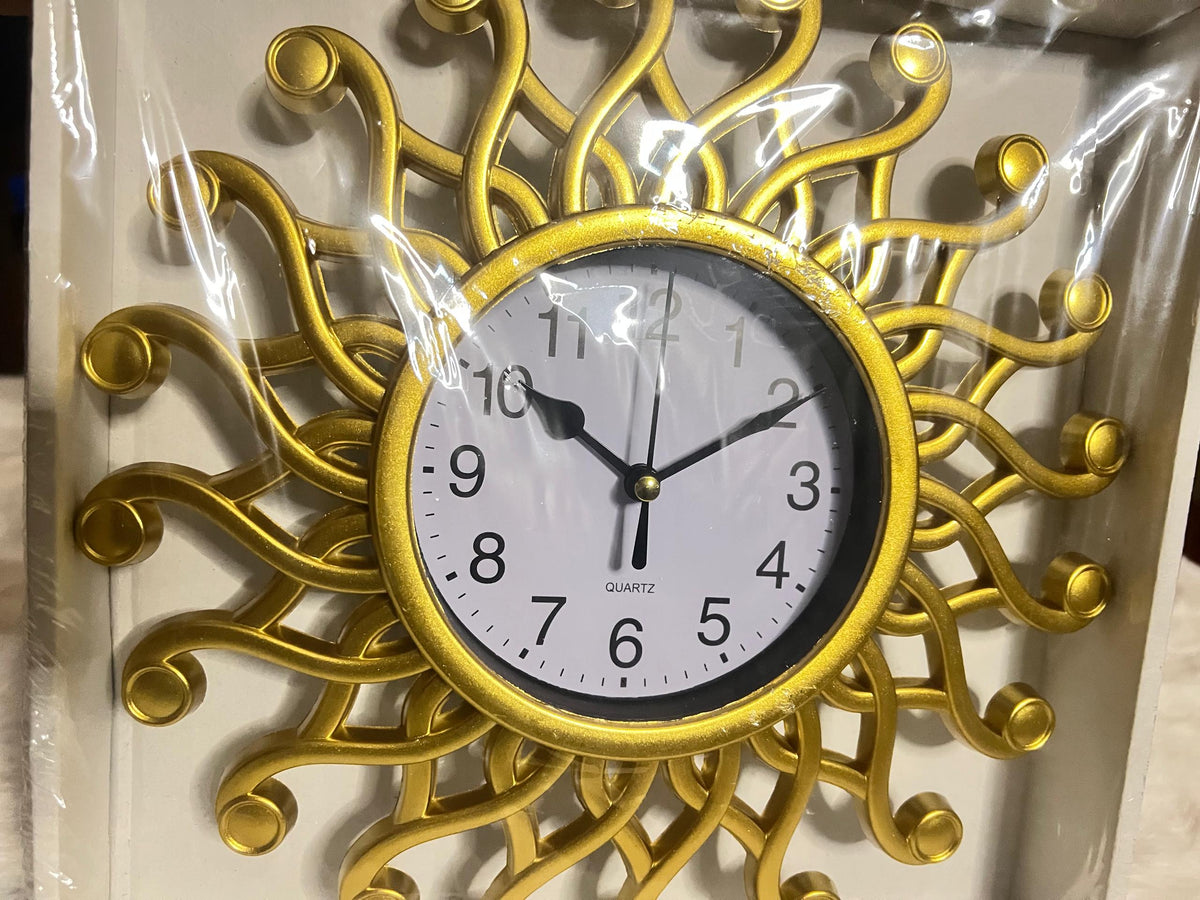A decorative wall clock with a gold sunburst frame