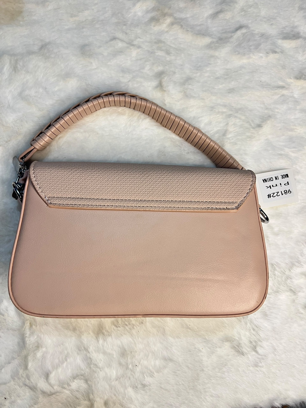 shoulder bag in a dusty pink pebbled leather with a textured flap