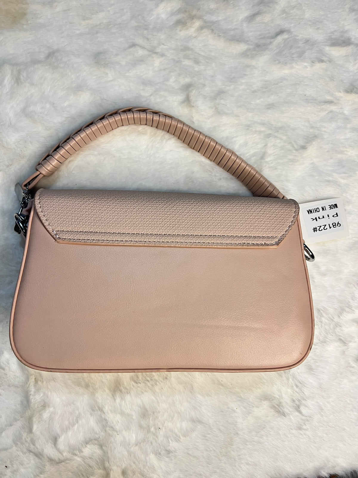 shoulder bag in a dusty pink pebbled leather with a textured flap