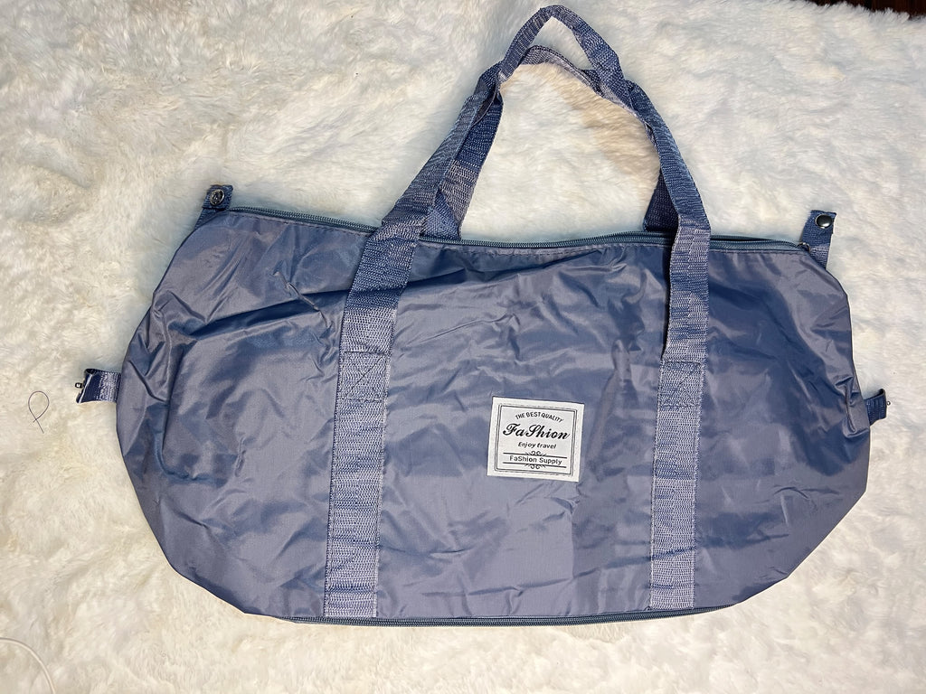 Blue travelling zippered duffel bag with dual shoulder straps
