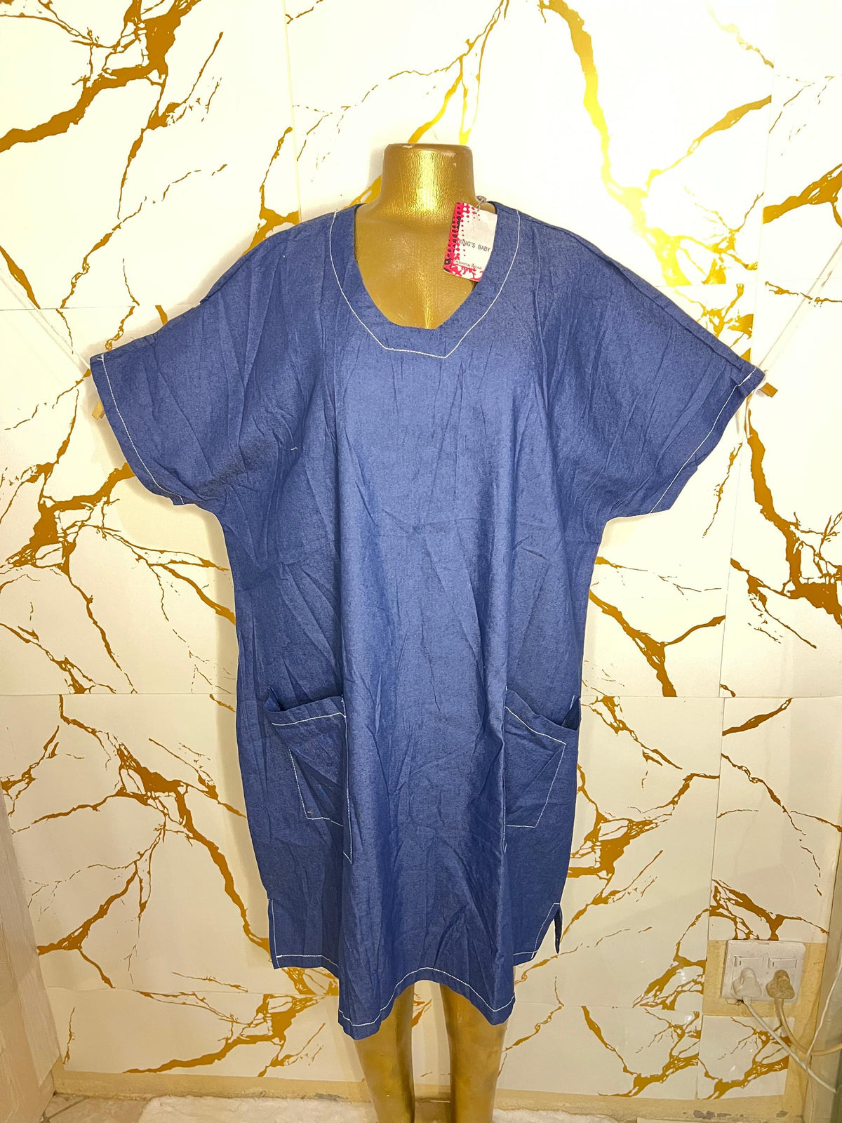 A blue short-sleeve scrub-style top