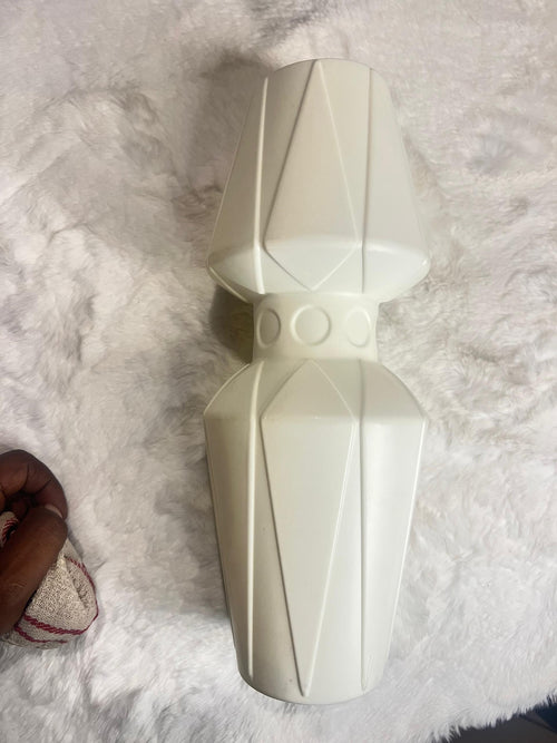A cream-colored geometric decorative vase