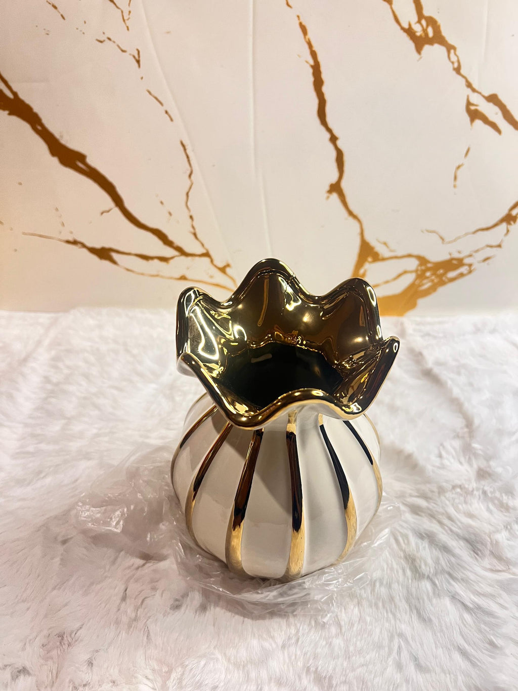 A decorative ceramic vase with a glossy white body