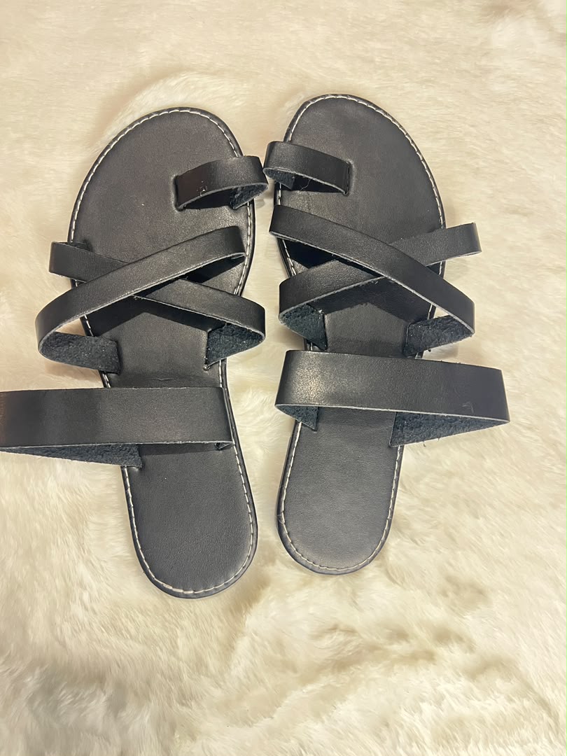 Black quilted leather ballet flats with metallic silver bow details on the toes