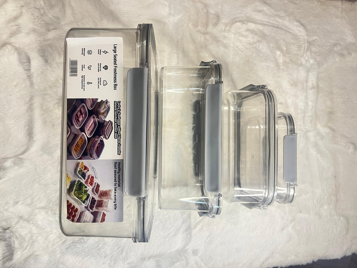 Set of three clear plastic storage containers with gray lids 