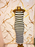 A sleeveless halter-neck maxi dress with horizontal black and white stripes 
