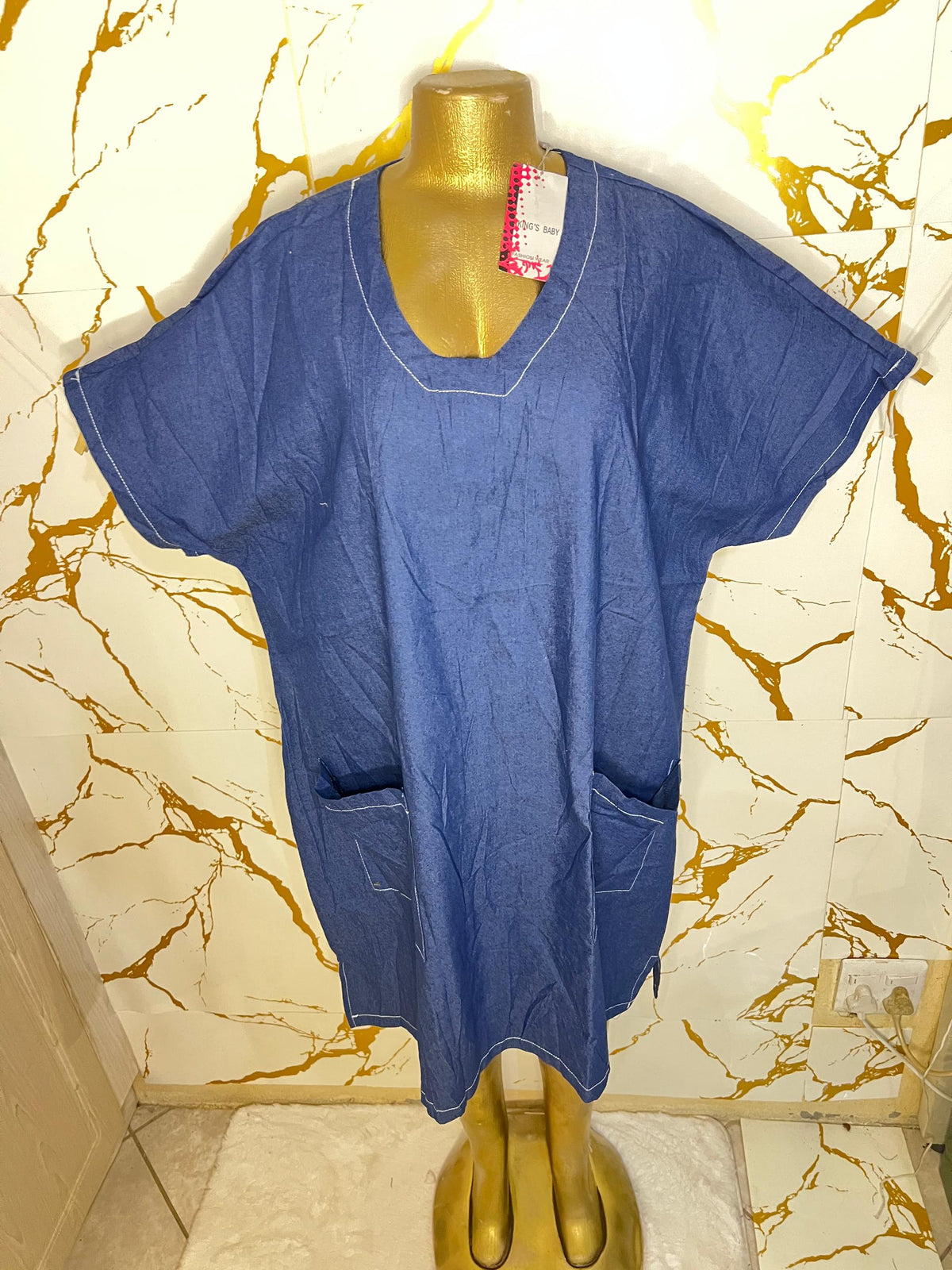 A blue short-sleeve scrub-style top 