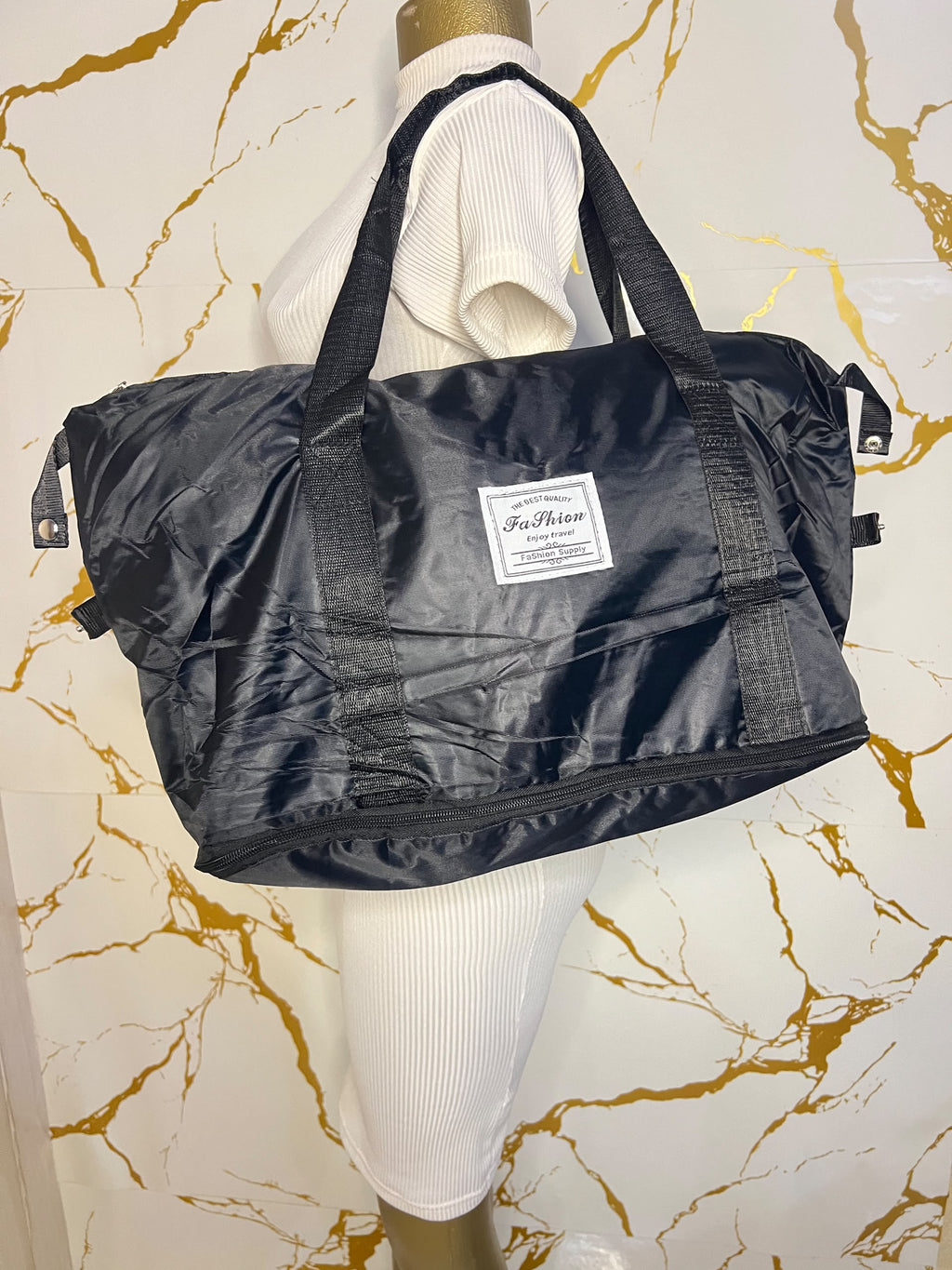 Black travelling zippered duffel bag with dual shoulder straps