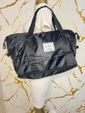 Black travelling zippered duffel bag with dual shoulder straps