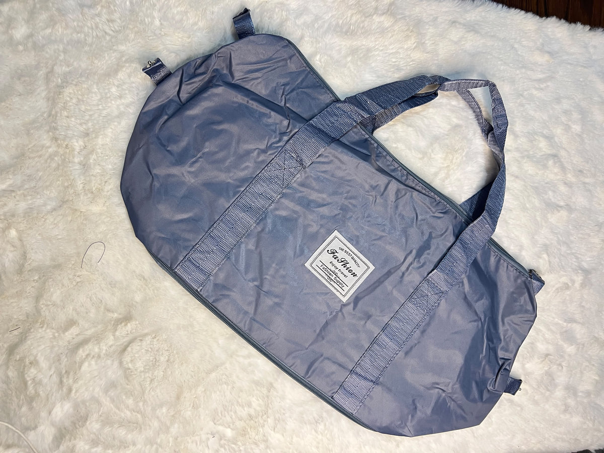 Blue travelling zippered duffel bag with dual shoulder straps