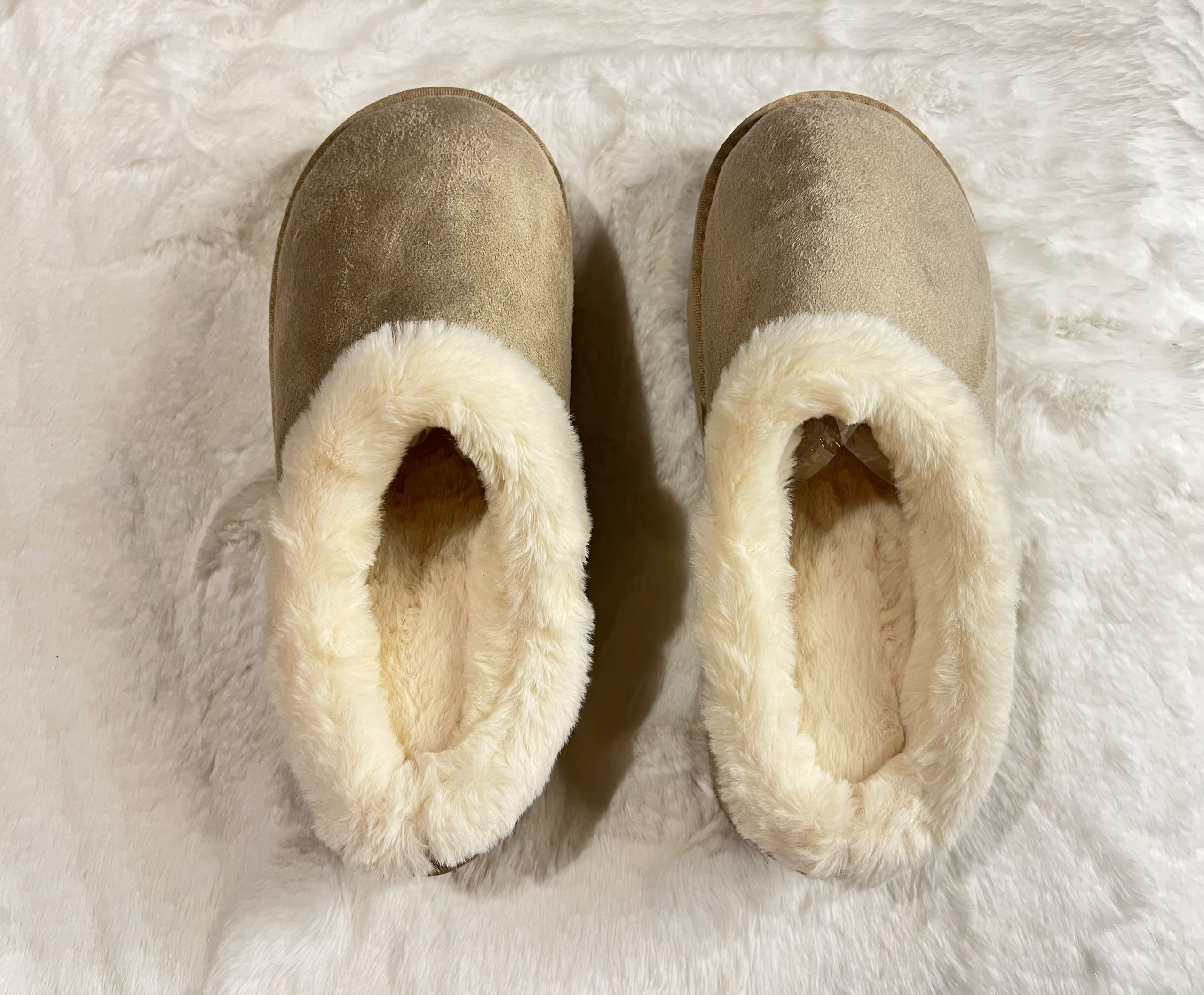 Taupe-brown suede slip-on slippers with thick cream faux-fur trim.