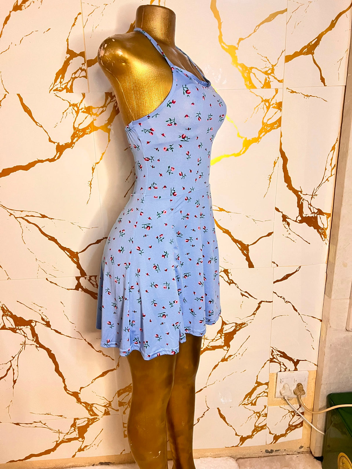 Light blue halter-neck mini dress with a small red and green floral print