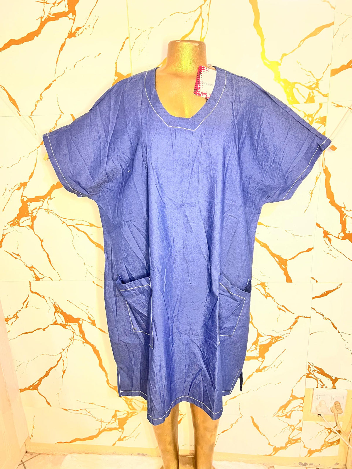 A blue short-sleeve scrub-style top