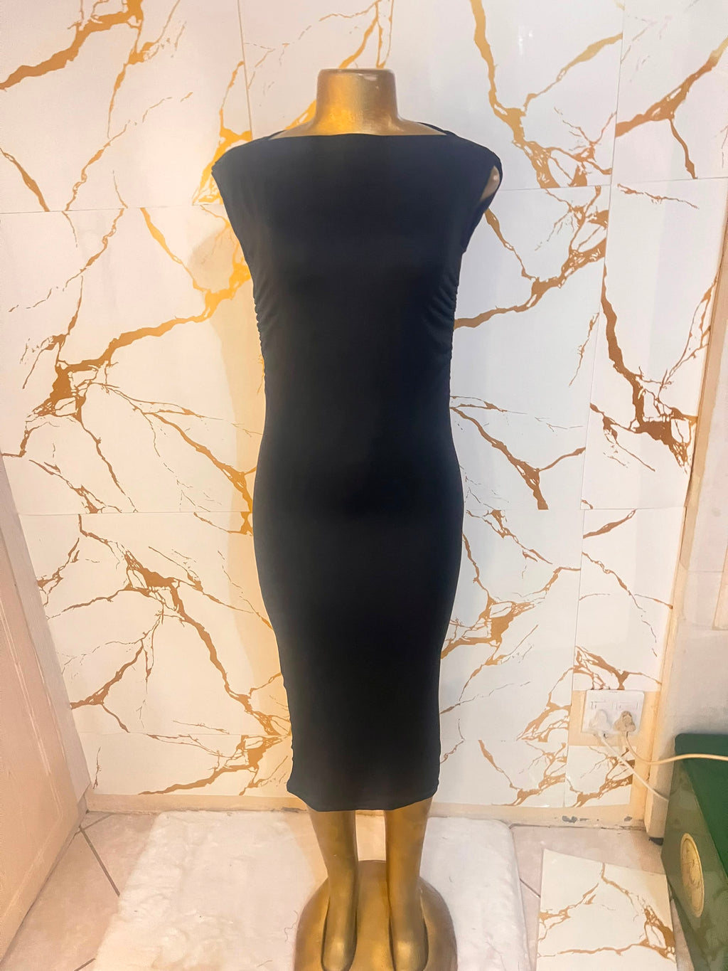 A sleeveless black bodycon dress