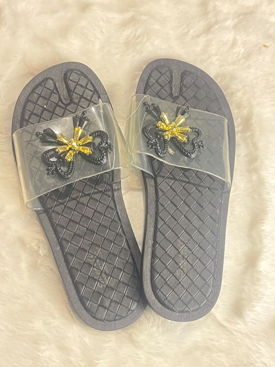black woven-texture slide sandals with clear plastic straps