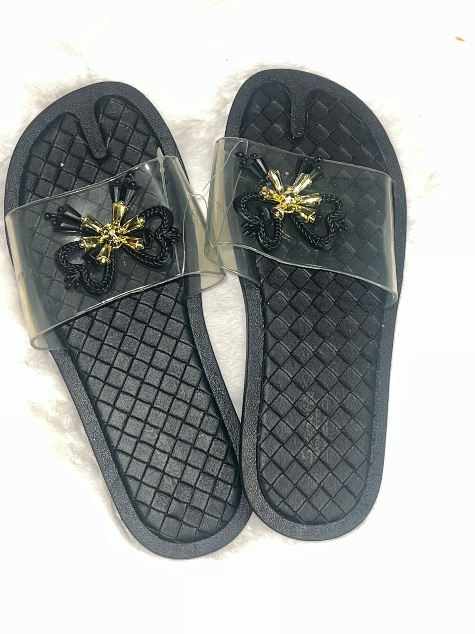 black woven-texture slide sandals with clear plastic straps
