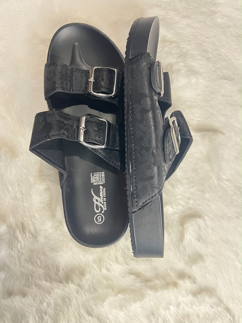 Black double-strap slide sandals with silver buckle closures