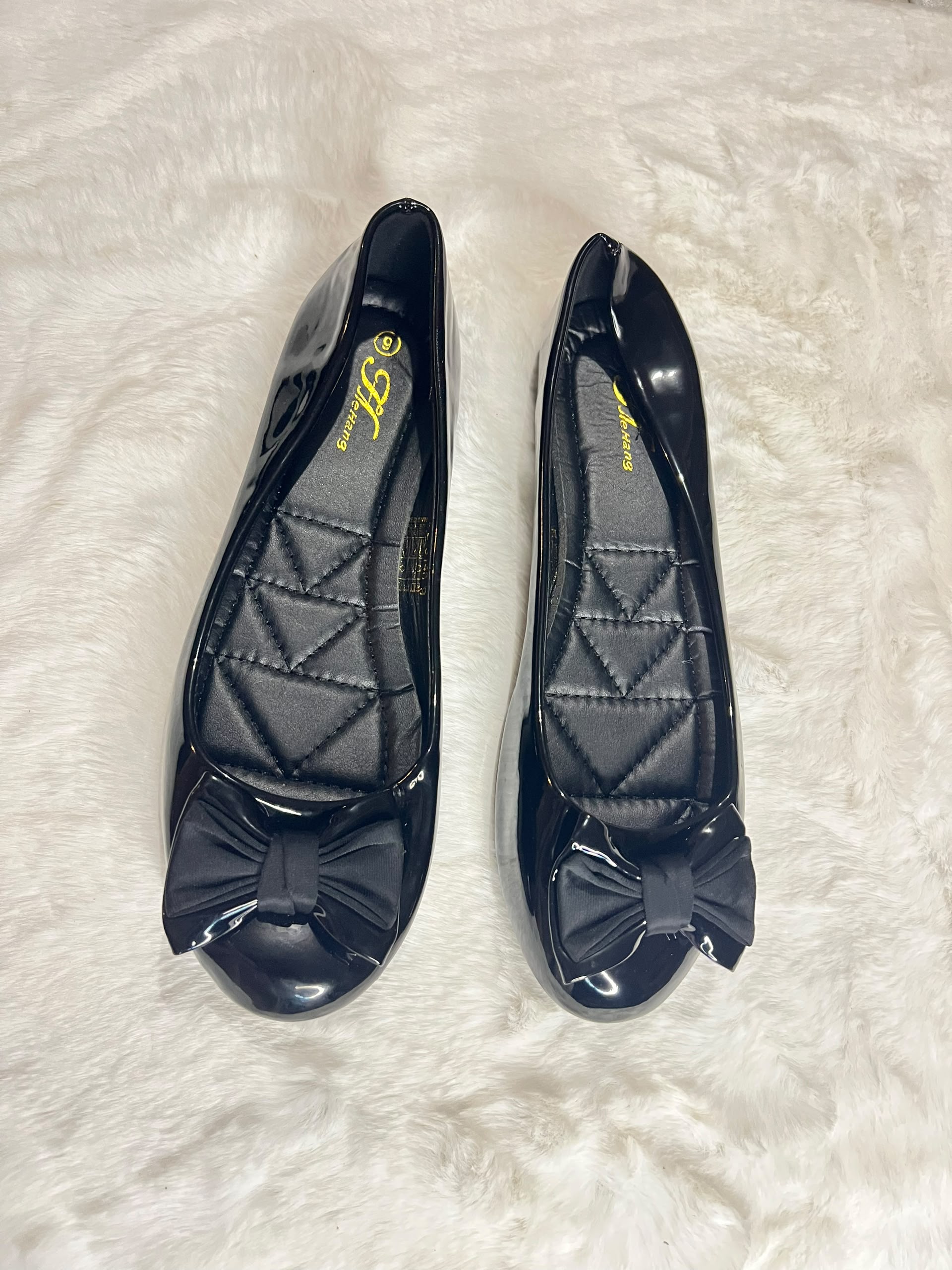 Black patent leather ballet flats with quilted insoles