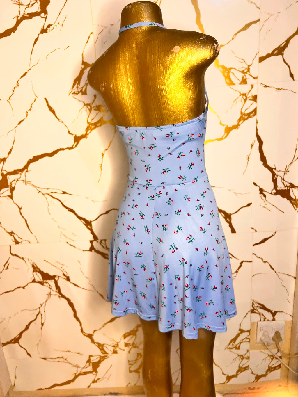 Light blue halter-neck mini dress with a small red and green floral print