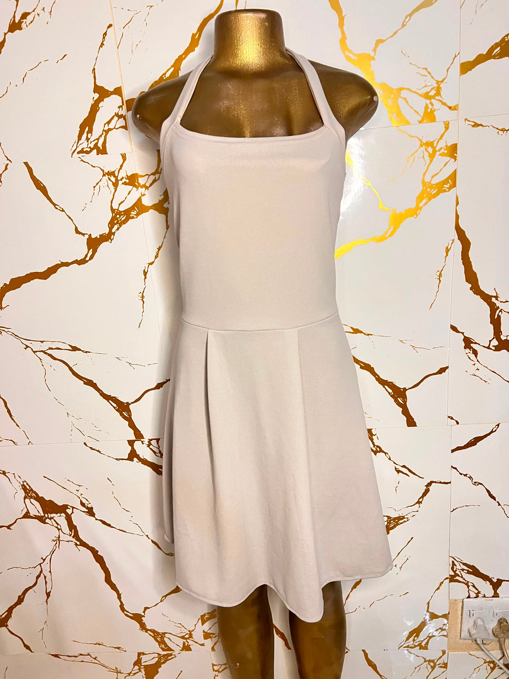 Sleeveless halter-neck dress in a light beige