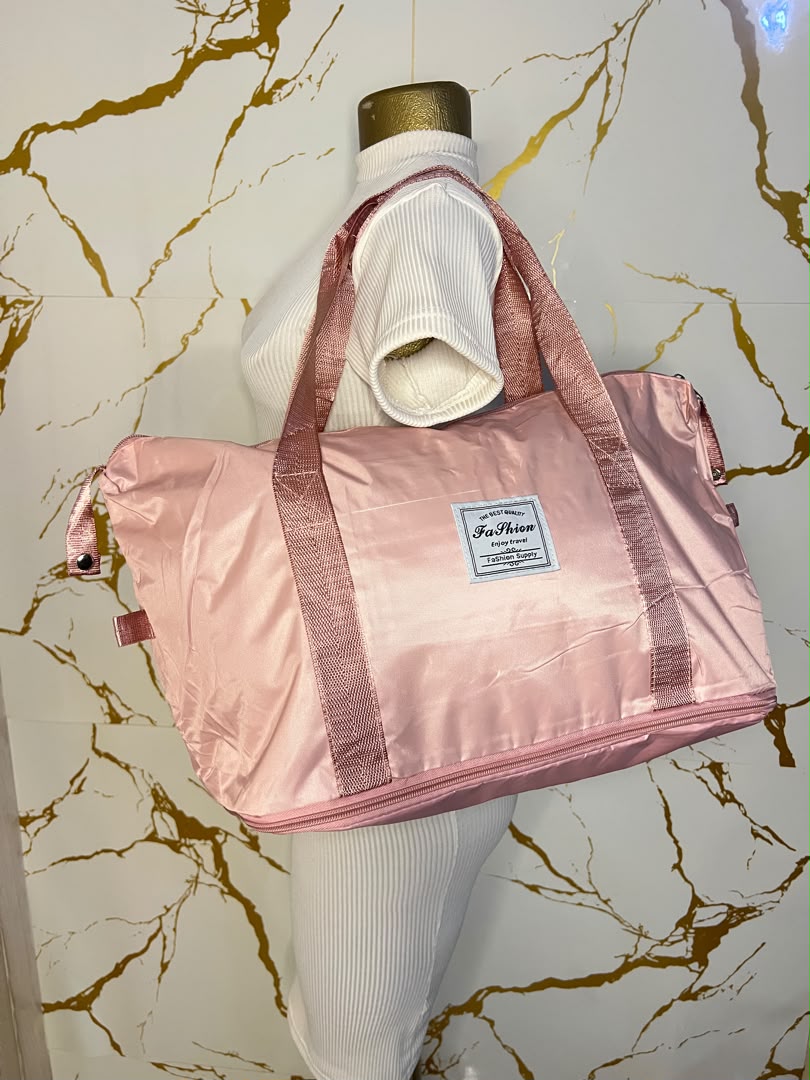A shiny light pink zippered duffel bag with dual shoulder straps