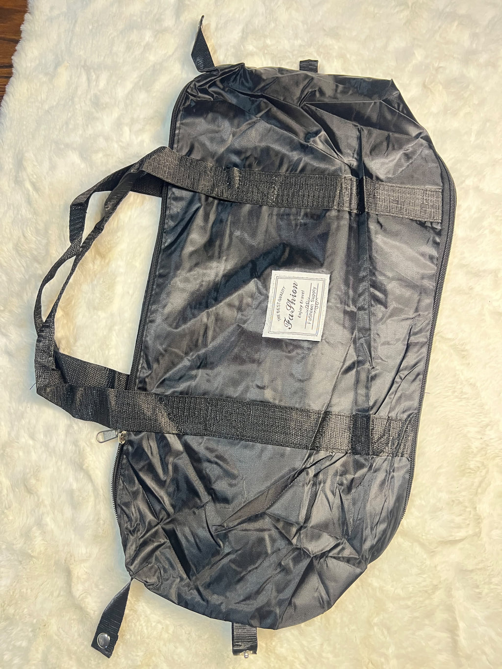 Black travelling zippered duffel bag with dual shoulder straps