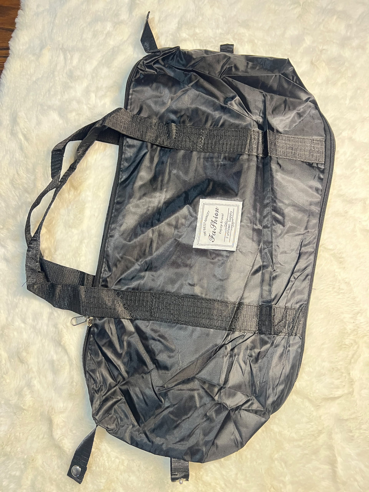 Black travelling zippered duffel bag with dual shoulder straps