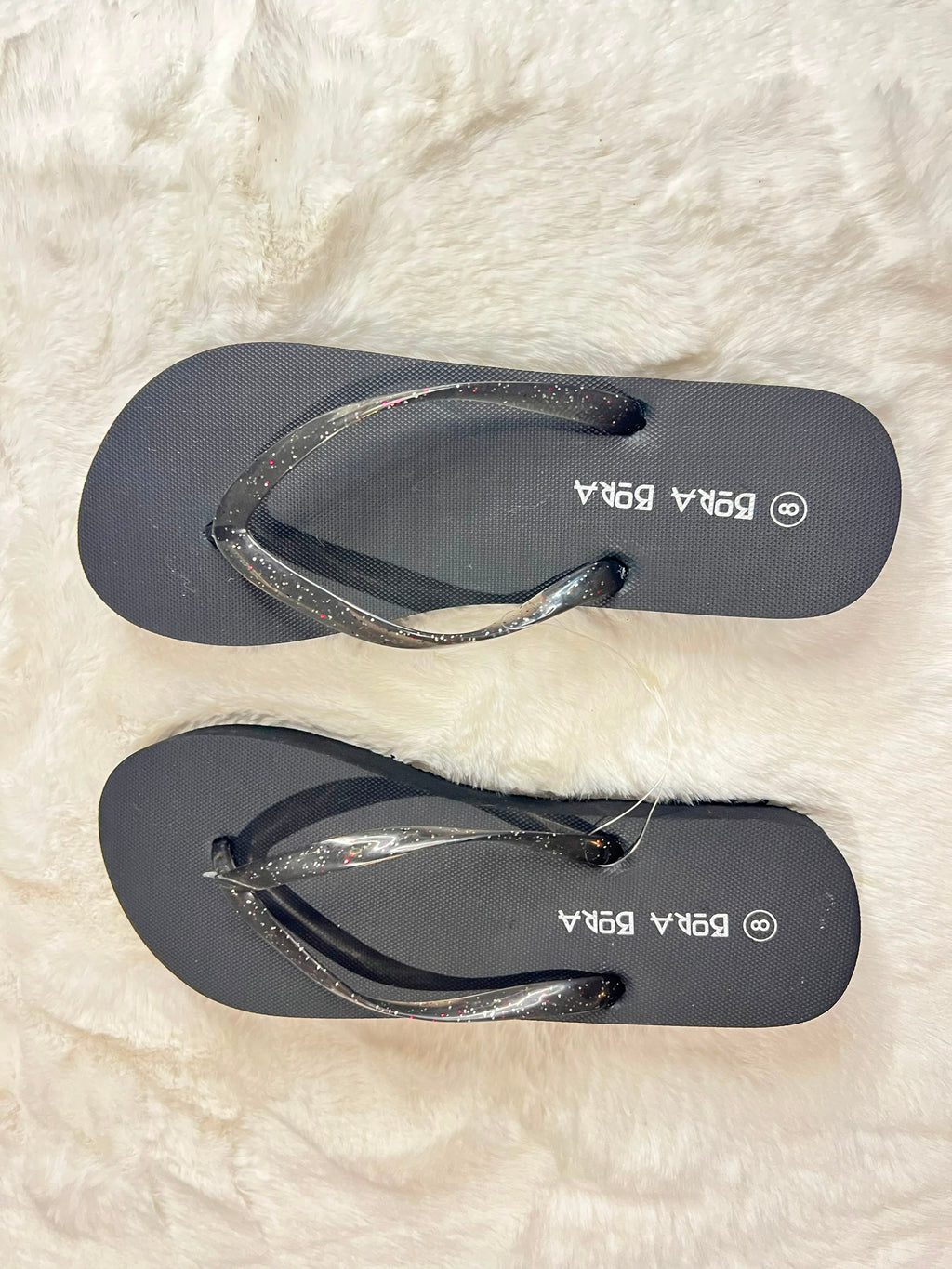 Black flip-flops with glittery metallic straps