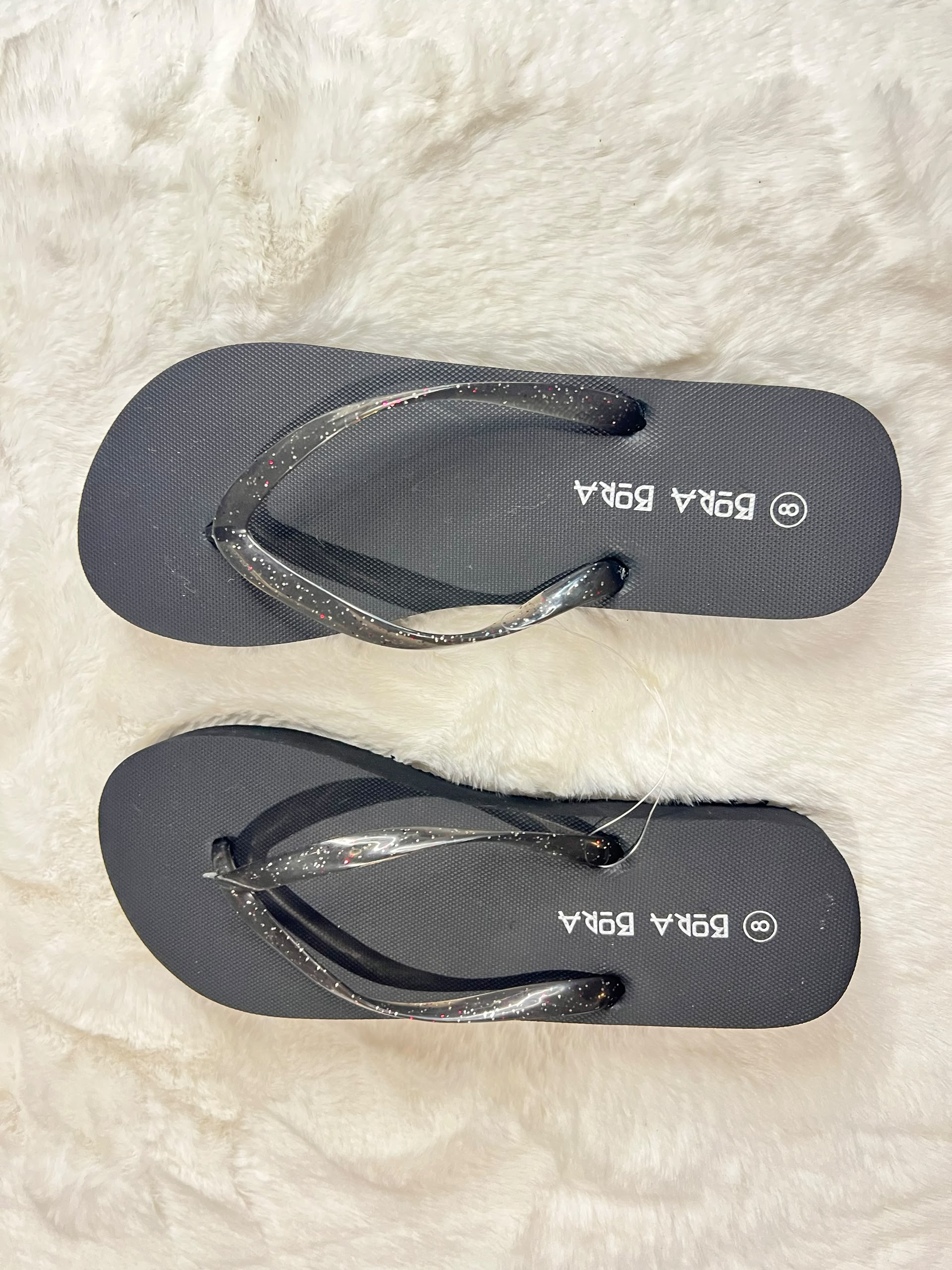 Black flip-flops with glittery metallic straps