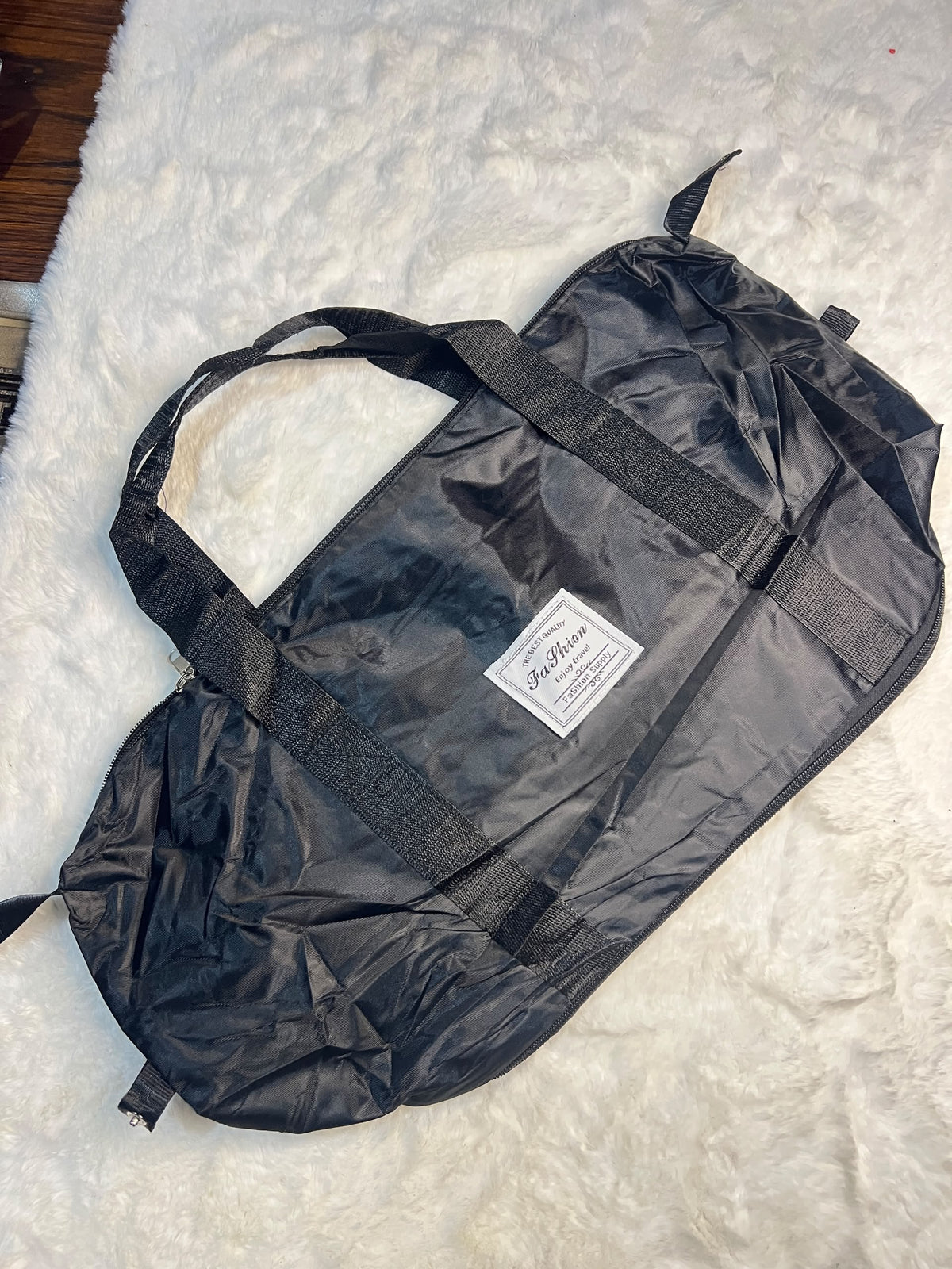 Black travelling zippered duffel bag with dual shoulder straps