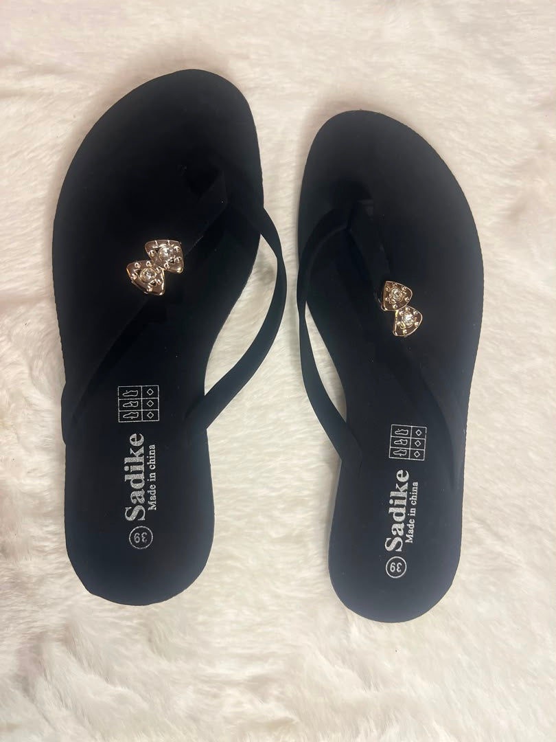 Black flip-flop sandals with rhinestone-embellished straps
