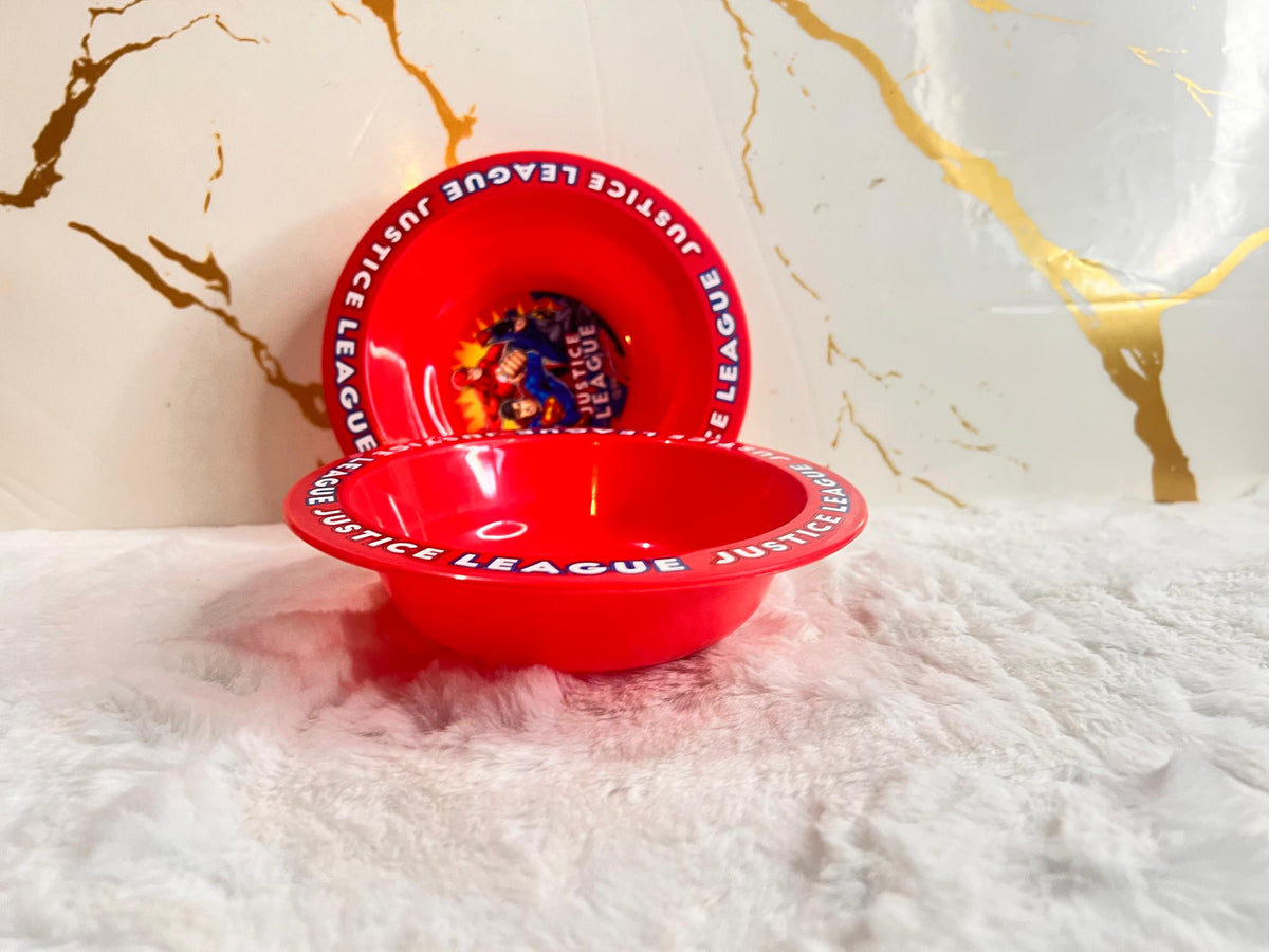 A red plastic bowl with 'JUSTICE LEAGUE' printed in white around the rim