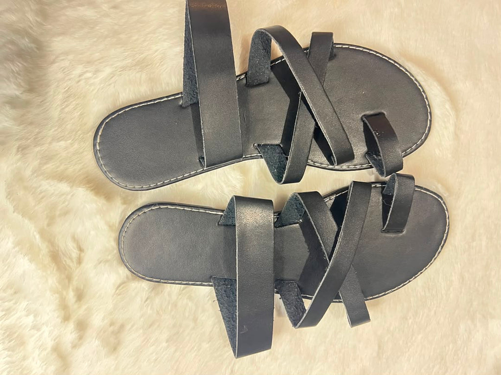 Black quilted leather ballet flats with metallic silver bow details on the toes
