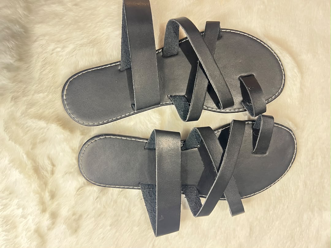 Black quilted leather ballet flats with metallic silver bow details on the toes