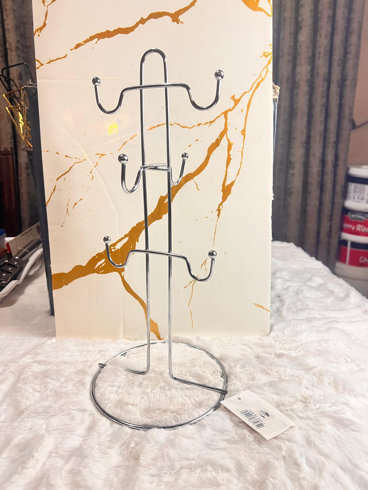 Two silver metal tea cup racks with multiple hooks