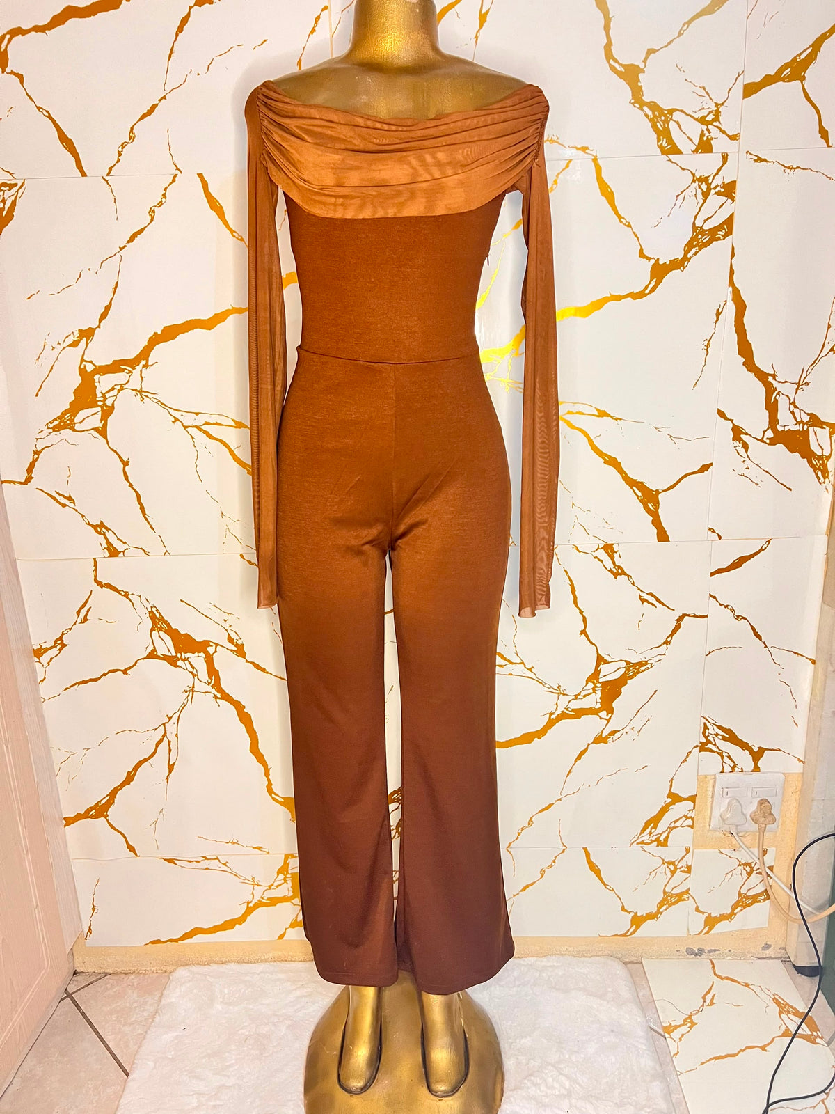 A rust-brown off-the-shoulder jumpsuit 