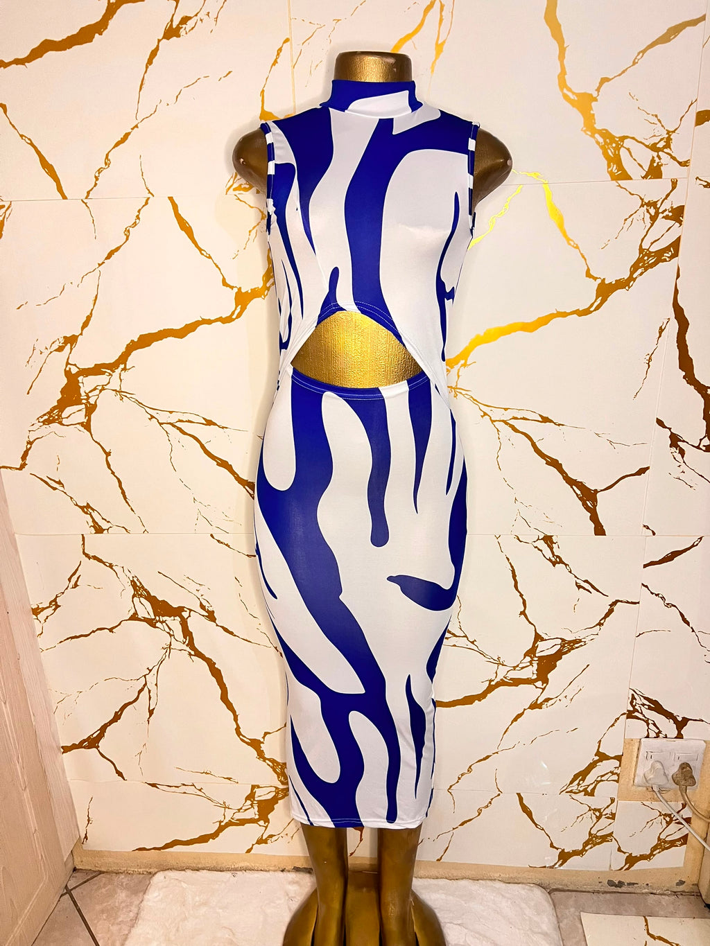 A sleeveless bodycon dress with a bold blue and white abstract wavy pattern