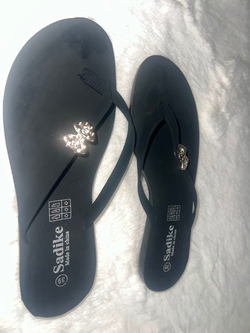 Black flip-flop sandals with rhinestone-embellished straps
