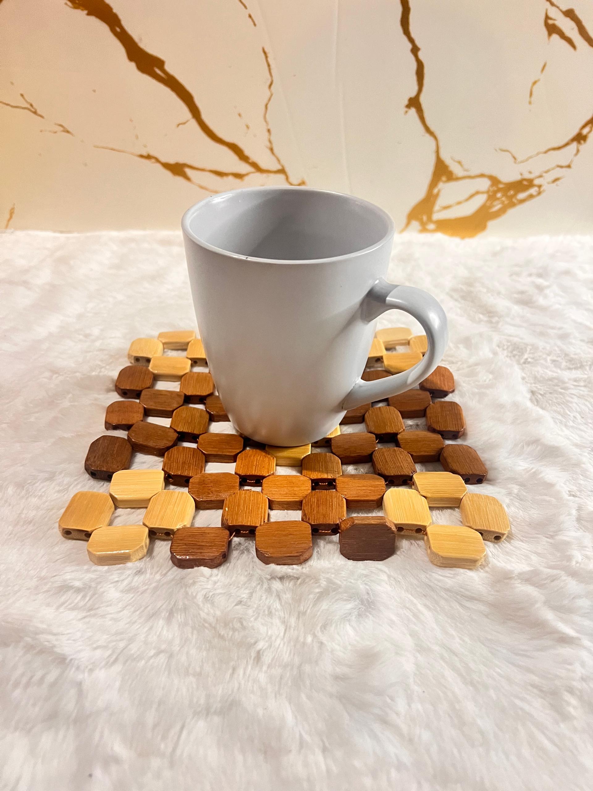 Coaster mat made of small octagonal wooden beads in various natural wood tones.