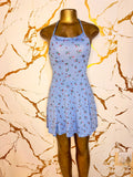A light blue halter-neck mini dress with a small red and green floral print