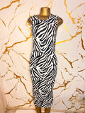 A sleeveless black and white zebra-patterned midi dress 