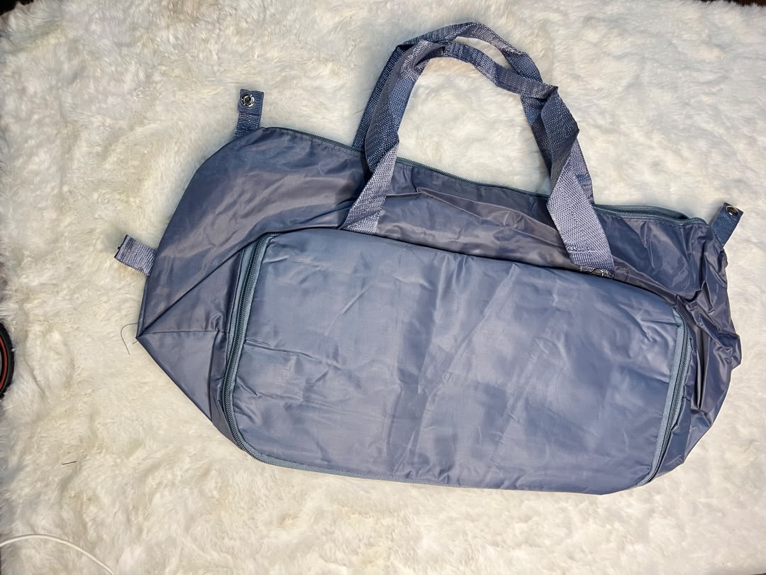 Blue travelling zippered duffel bag with dual shoulder straps