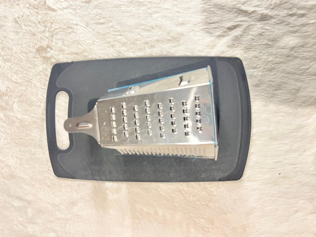 Stainless steel box grater with a dark gray handle