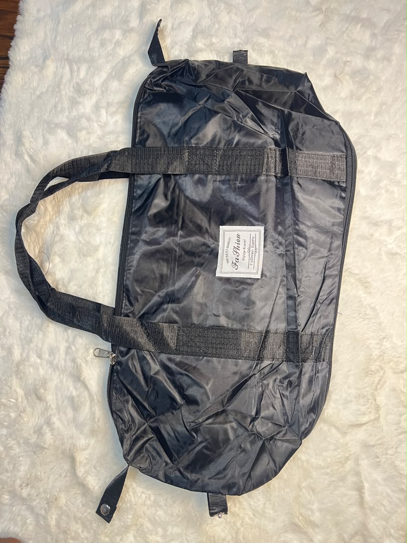 Black travelling zippered duffel bag with dual shoulder straps